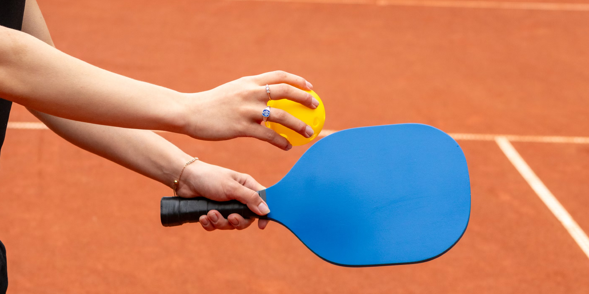 A player about to take a pickleball serve