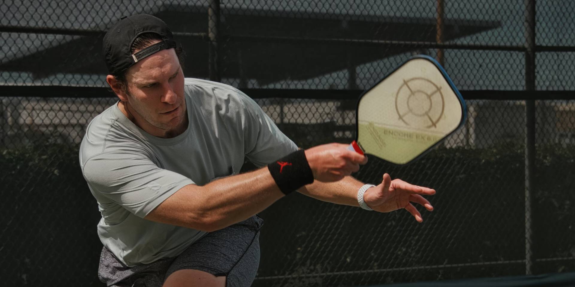 A man after taking a big forehand shot