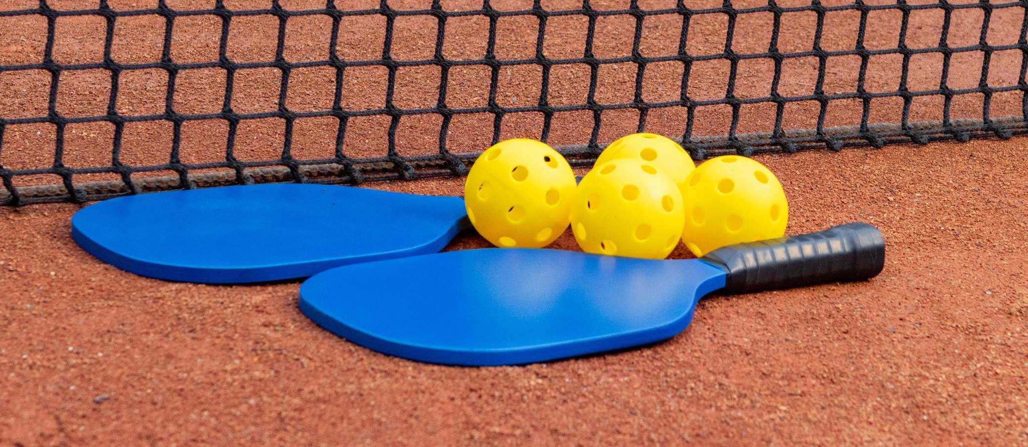 A pickleball ball on a pickleball court.